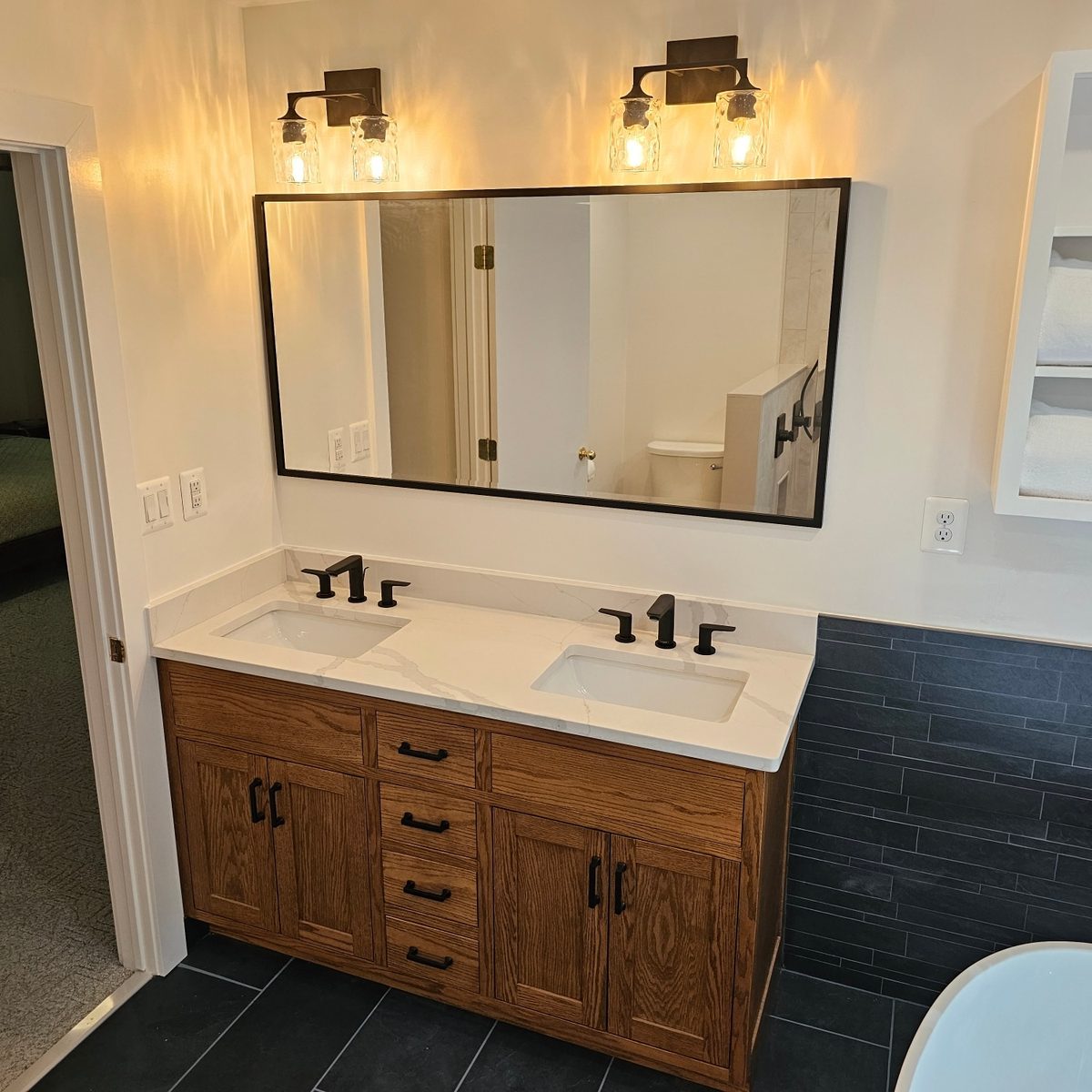 Double vanity with oak cabinet and quartz countertop