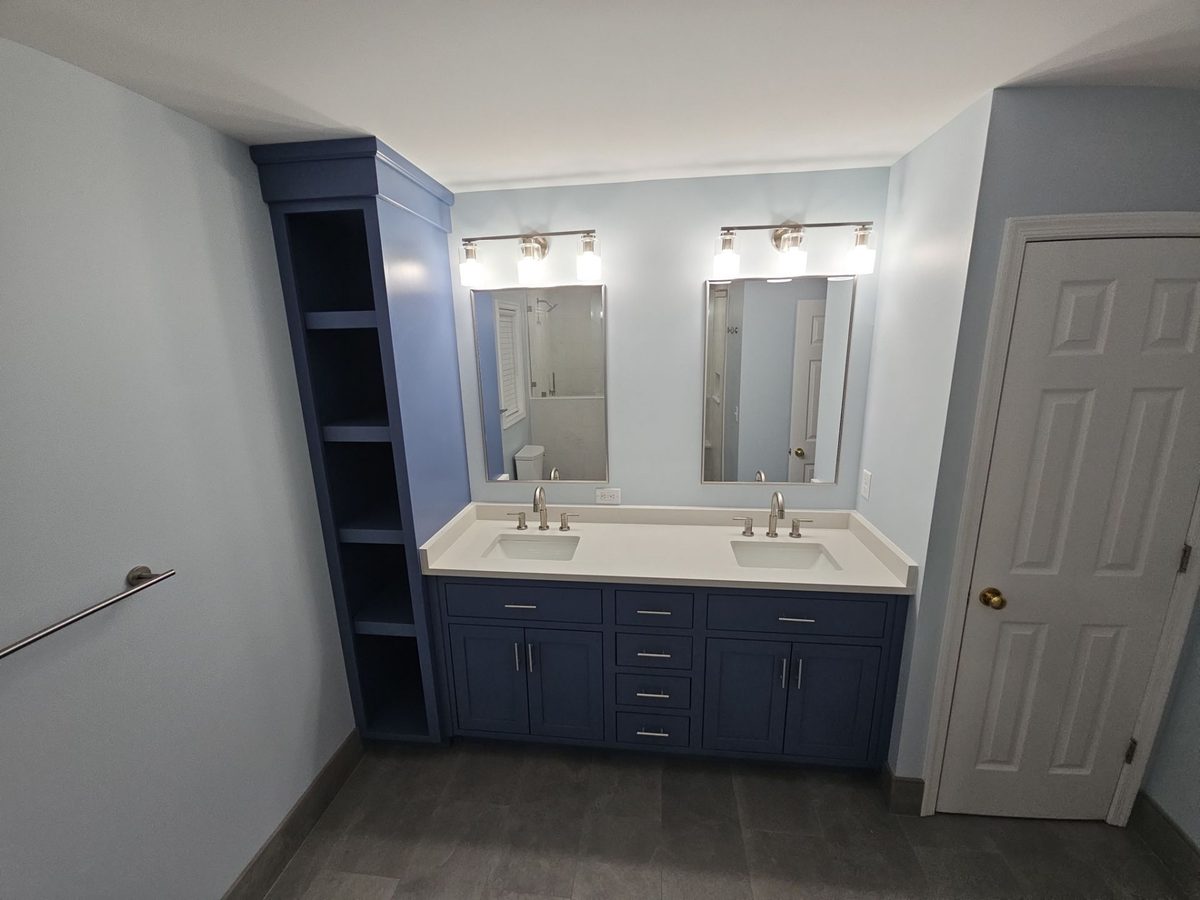 Bedford — navy blue double vanity with built-in linen tower and brushed nickel fixtures