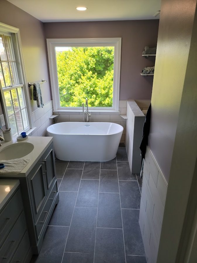 Village — freestanding soaker tub with large picture window and coordinated shelving
