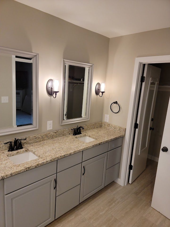 Saddle Ridge — custom double vanity with granite countertop and oil-rubbed bronze fixtures